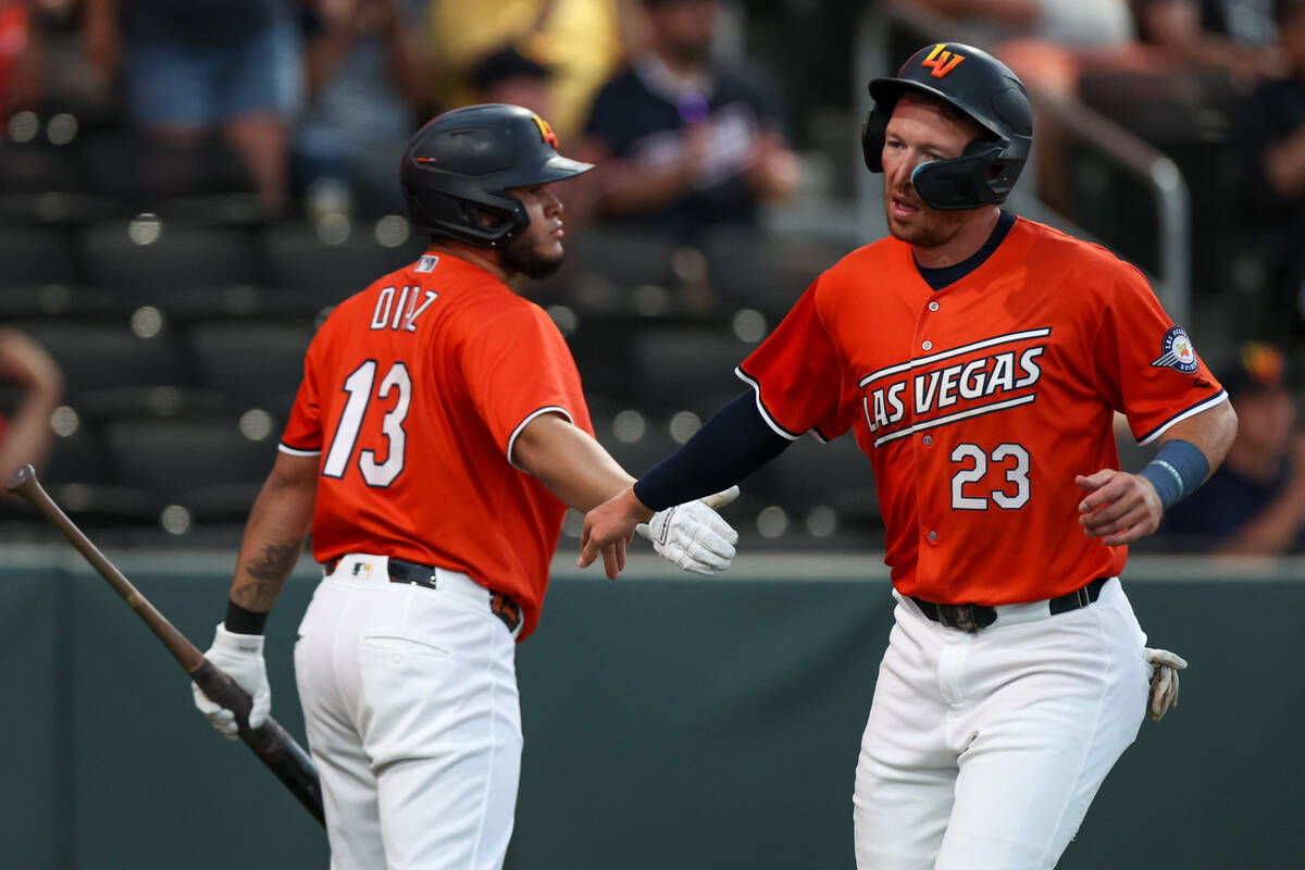 Las Vegas Aviators infielder Jordan Diaz (13) high-fives infielder Brett Harris (23) after he ...