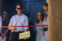 William Huggins cuts the ribbon to his home at an event highlighting the use of Inflation Reduc ...