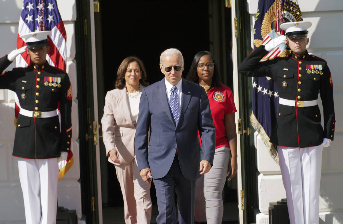 President Joe Biden arrives with Vice President Kamala Harris and Lovette Jacobs, a fifth-year ...