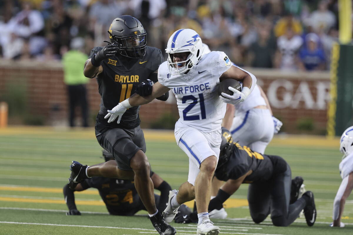 Air Force wide receiver Cade Harris attempts to slip past Baylor linebacker Keaton Thomas durin ...