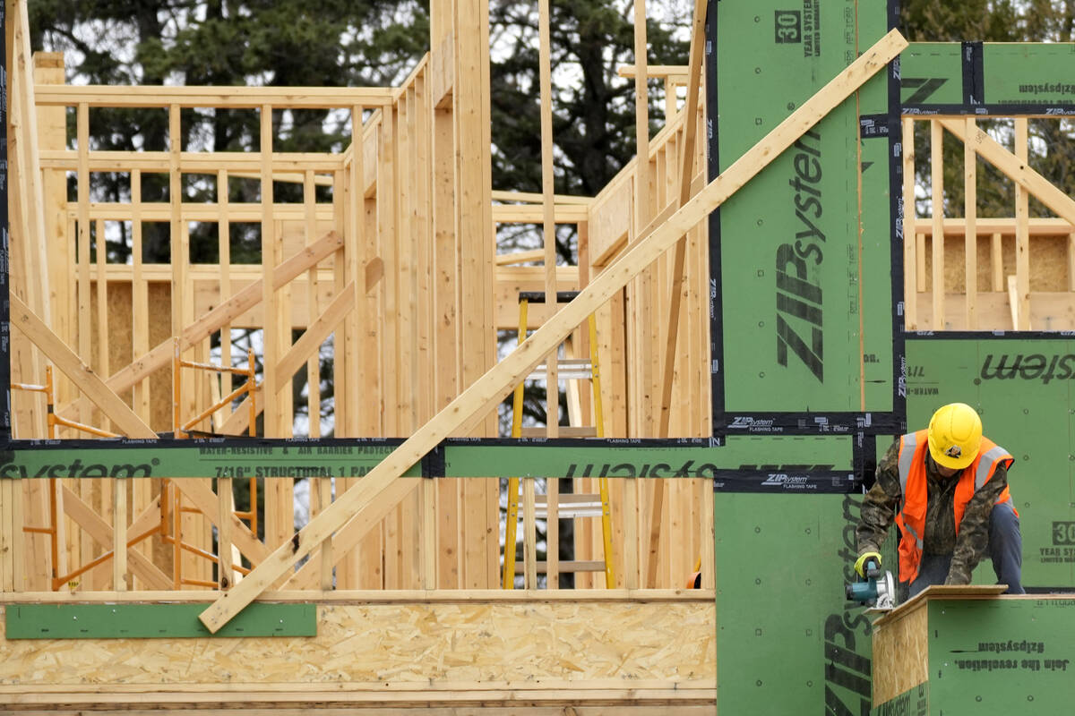 A construction worker cuts wood at a residential building site in Mount Prospect, Ill., on Marc ...