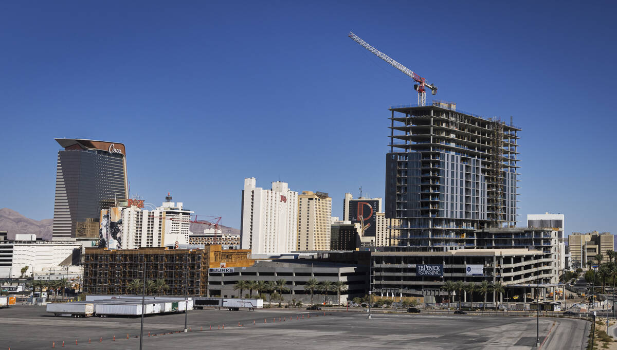 Luxury apartment high-rise Capella is seen under construction alongside Bria, left, at Symphony ...