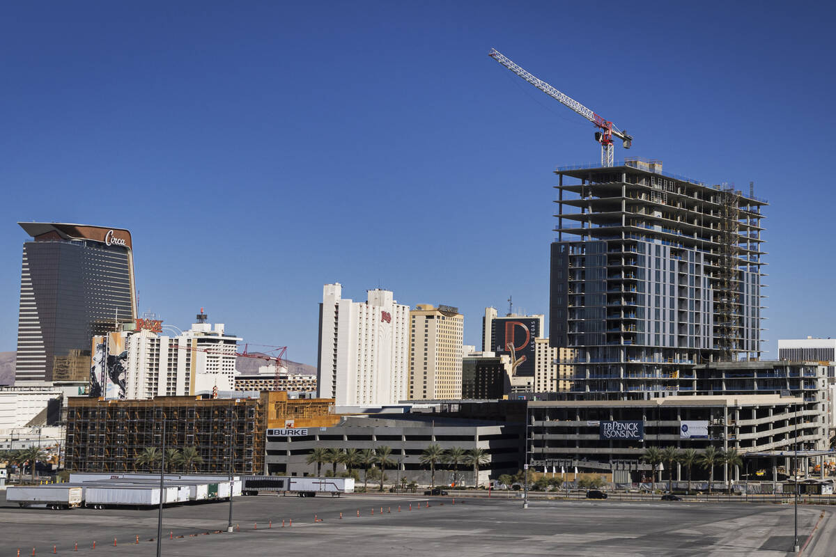 Luxury apartment high-rise Capella is seen under construction alongside Bria, left, at Symphony ...