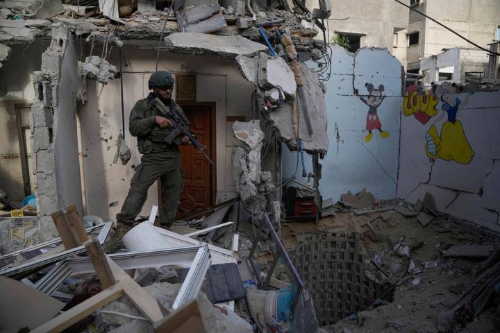 An Israeli soldier stands at the entrance of a tunnel where the military says six Israeli hosta ...