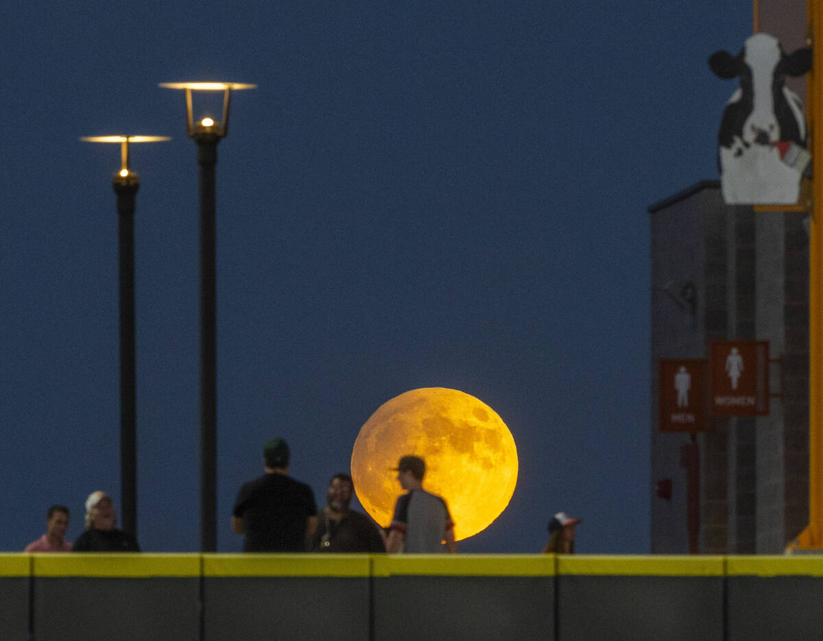 A Harvest Supermoon rises as fans gather on the wall for the Aviators against the El Paso Chihu ...