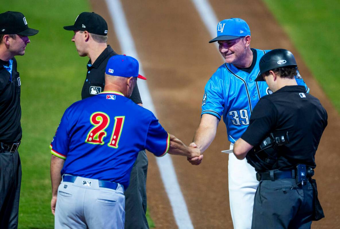 Aviators manager Fran Riordan and El Paso Chihuahuas bench coach Pete Zamora greet along with u ...