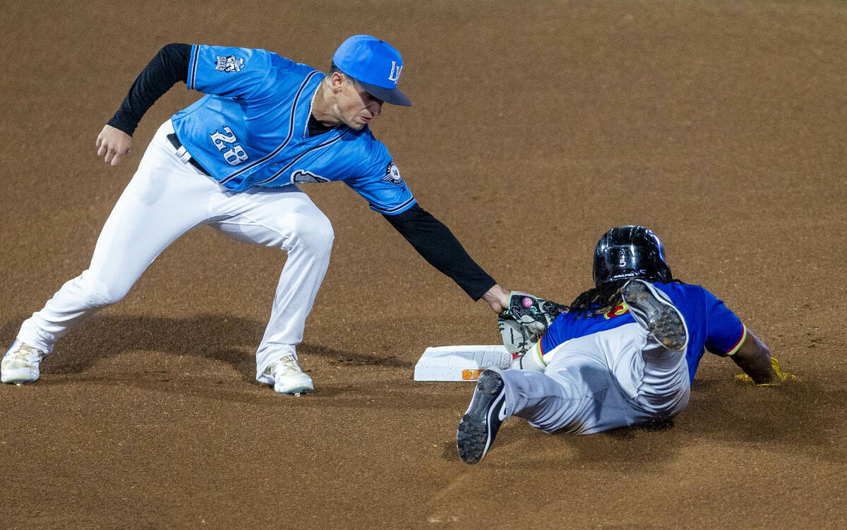 Aviators infielder Armando Alvarez (28) attempts to tag El Paso Chihuahuas infielder Eguy Rosar ...