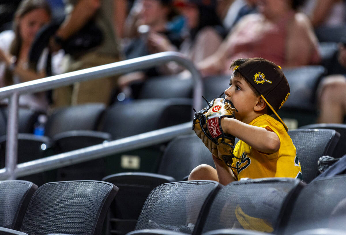 A young fan chews on his glove as the Aviators battle the El Paso Chihuahuas during their base ...