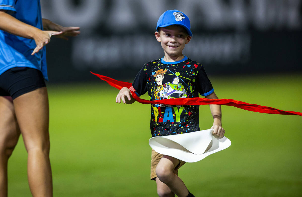 A young boy crosses the finish line in a race as the Aviators battle the El Paso Chihuahuas dur ...