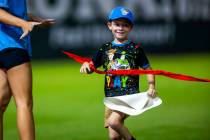 A young boy crosses the finish line in a race as the Aviators battle the El Paso Chihuahuas dur ...