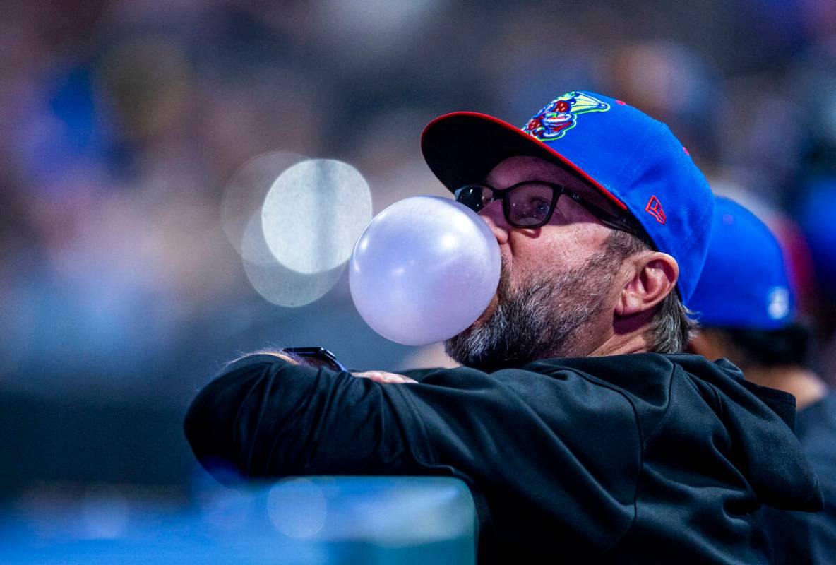 An El Paso Chihuahuas coach blows bubbles in the dugout as they face the Aviators during their ...