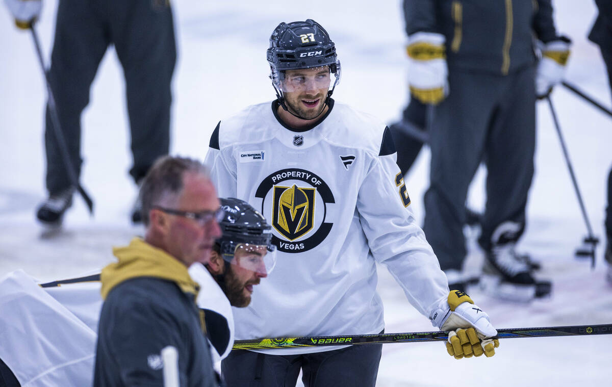 Golden Knights defenseman Shea Theodore (27) watches a drill with teammates during the first da ...