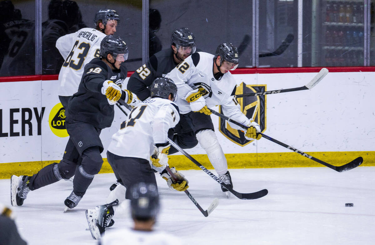 Golden Knights center Jakub Brabenec (12) chases the puck against teammates during the first da ...