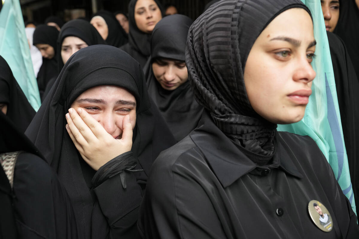 A girl cries during the funeral procession of two Hezbollah members, killed on Wednesday when a ...