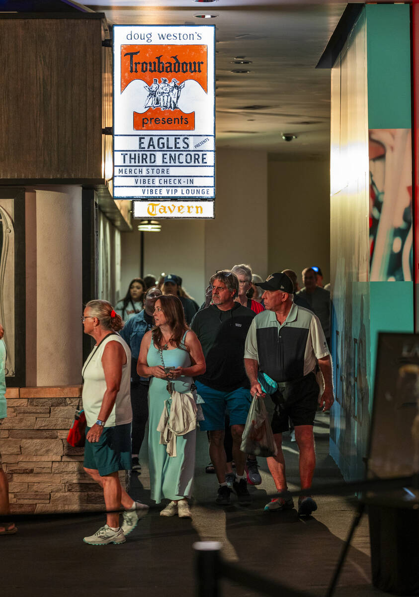 Fans walk along the entry way and around a corner to the Troubadour replica within the Eagles e ...