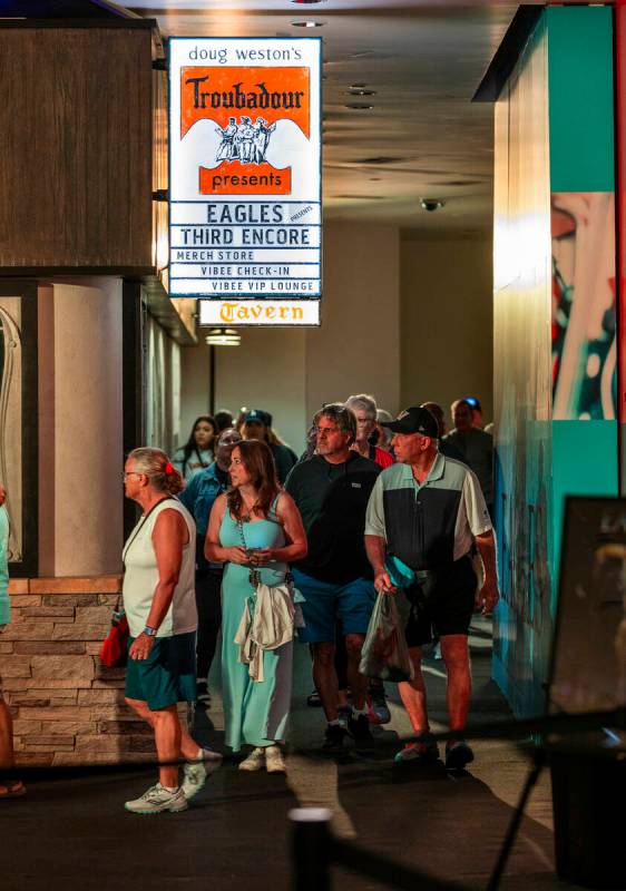 Fans walk along the entry way and around a corner to the Troubadour replica within the Eagles e ...