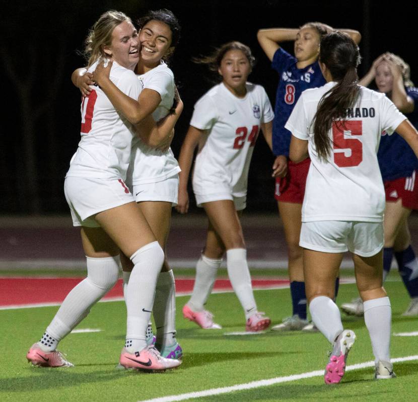 Coronado junior Ryan Neel (10) and freshman Taylor Takahashi (1) hug after a goal is scored dur ...