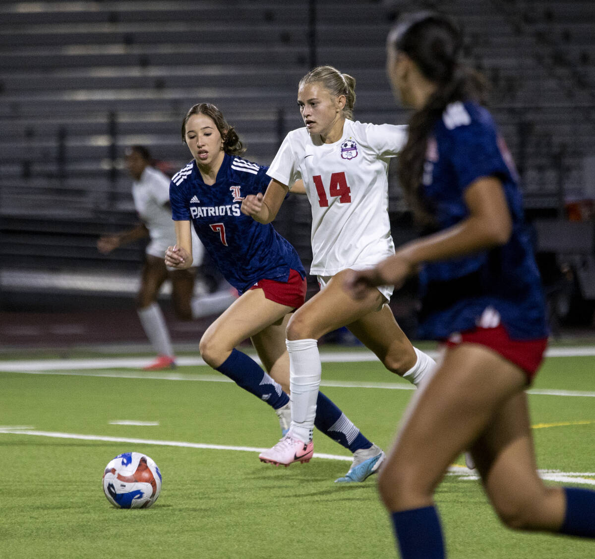 Coronado junior Allison Kleiner (14) and Liberty senior Nale'a Pomaikai (7) run after the ball ...