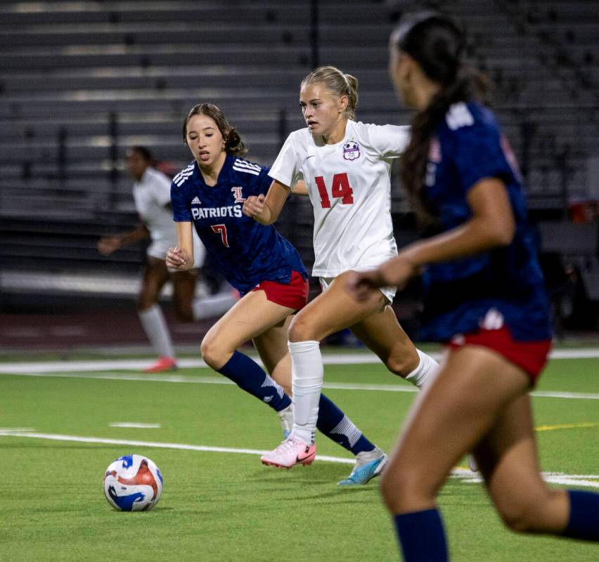 Coronado junior Allison Kleiner (14) and Liberty senior Nale'a Pomaikai (7) run after the ball ...