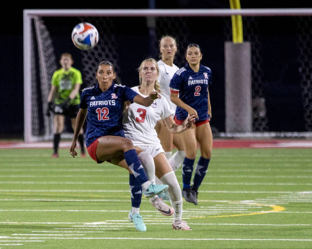 Liberty junior Ayva Jordan (12) and Coronado junior Alexandra Milano (3) compete for the ball d ...