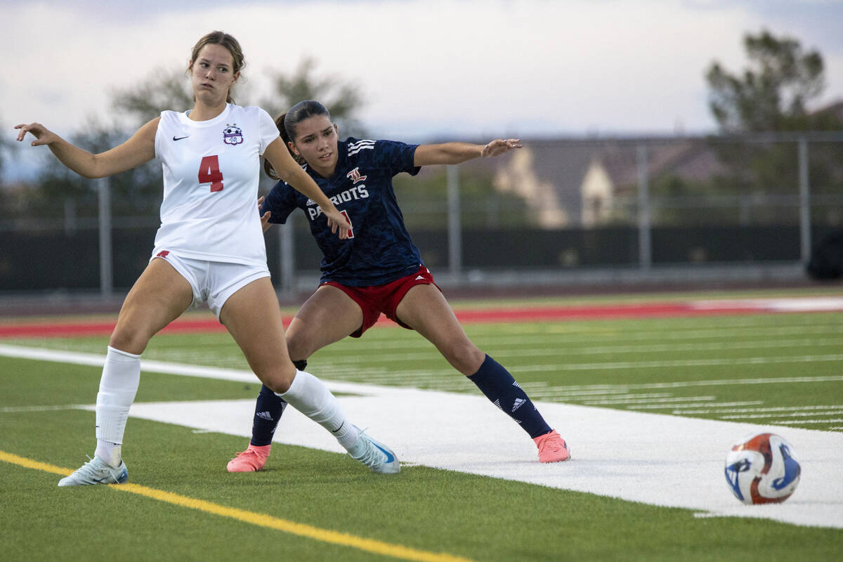 Coronado sophomore Ella Schultz (4) and Liberty junior Lillian Hastings (1) compete for the bal ...