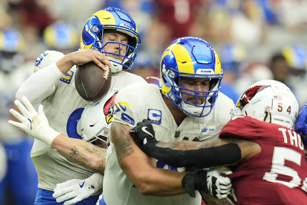 Los Angeles Rams quarterback Matthew Stafford (9) is sacked by Arizona Cardinals linebacker Den ...