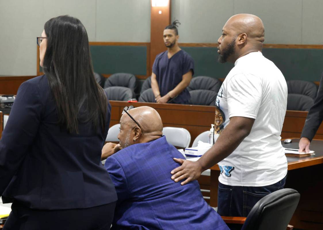 Gerry Jackson, sitting, the father of a murder victim Destiny Nicole Jackson, is comforted by h ...