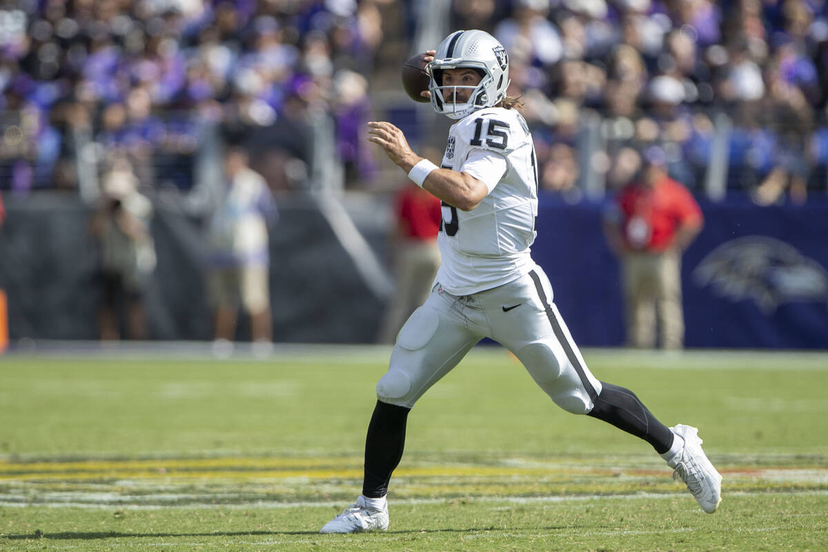 Raiders quarterback Gardner Minshew (15) makes a throw on the run during the first half of an N ...