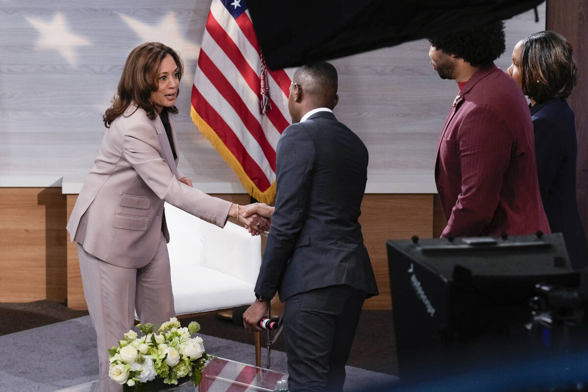 Democratic presidential nominee Vice President Kamala Harris, left, shaking hands with Gerren K ...