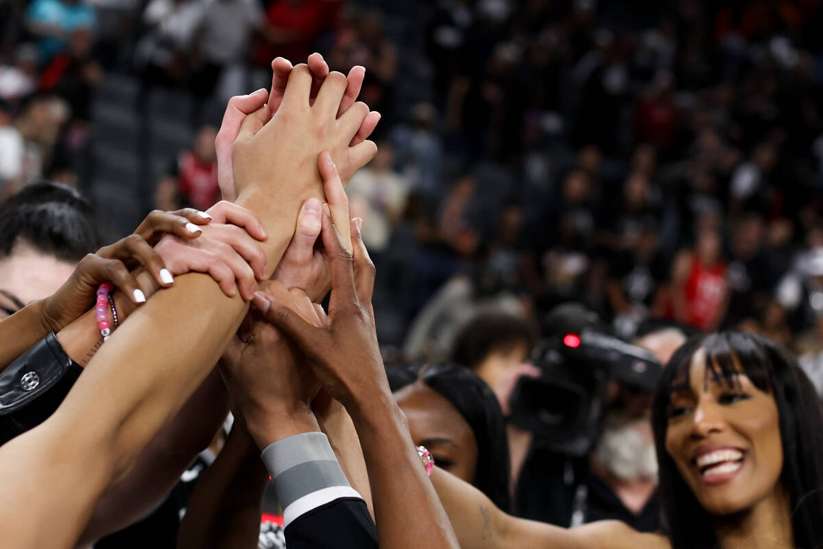 The Las Vegas Aces gather after winning a WNBA basketball game against the Dallas Wings at Mich ...