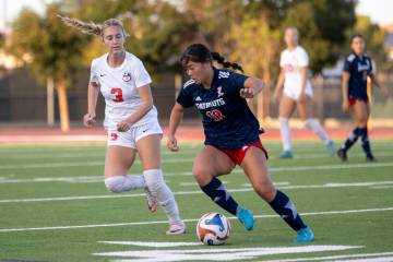 Liberty junior Kaimiinameapono Wills (18) keeps the ball away from Coronado junior Alexandra Mi ...