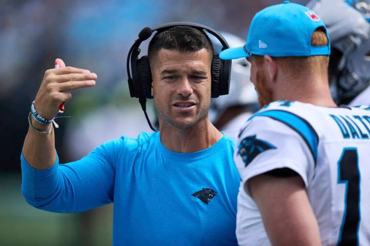 Carolina Panthers head coach Dave Canales talks to backup quarterback Andy Dalton (14) during a ...