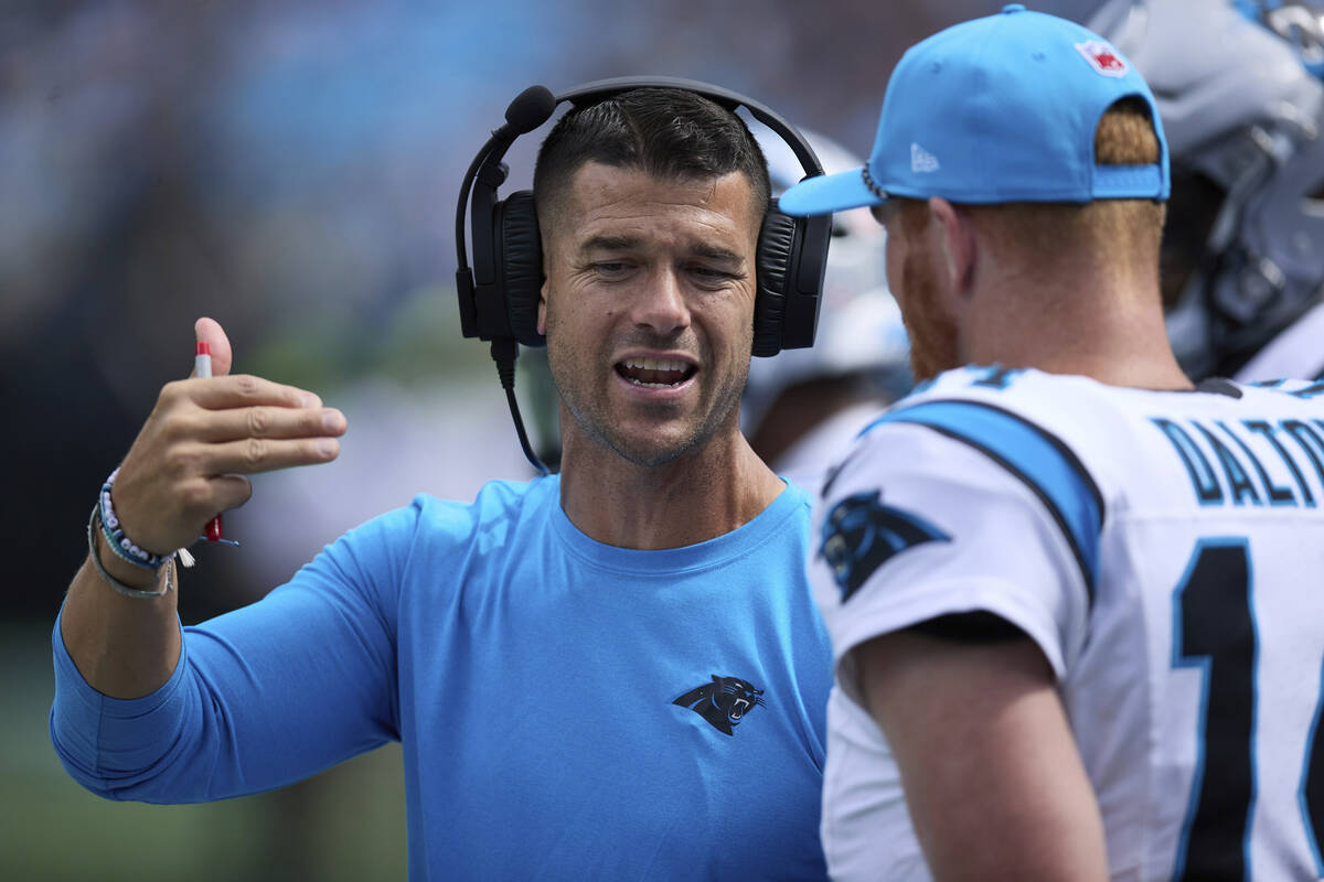 Carolina Panthers head coach Dave Canales talks to backup quarterback Andy Dalton (14) during a ...