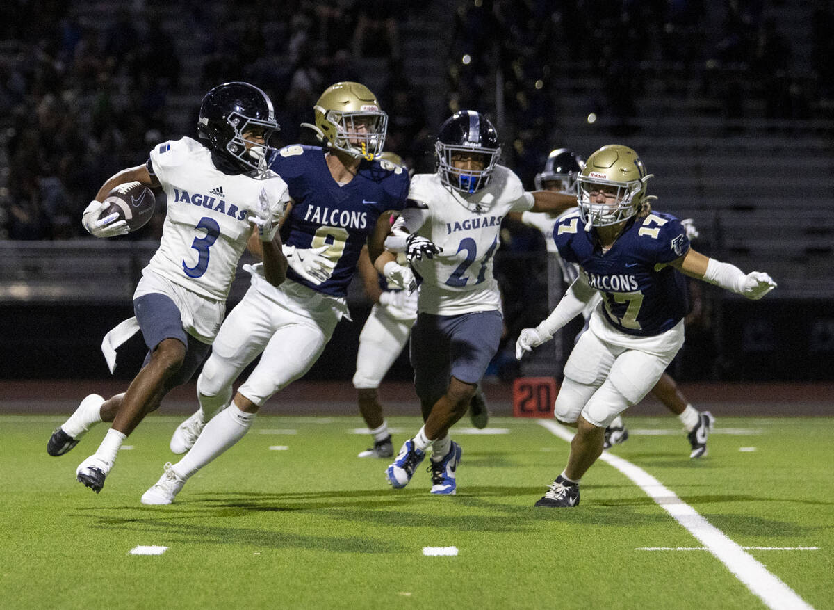 Desert Pines wide receiver Jaxon Sharp (3) runs the ball during the high school football game a ...