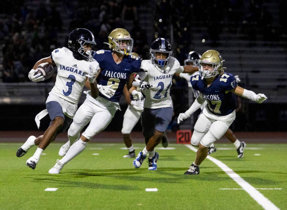 Desert Pines wide receiver Jaxon Sharp (3) runs the ball during the high school football game a ...