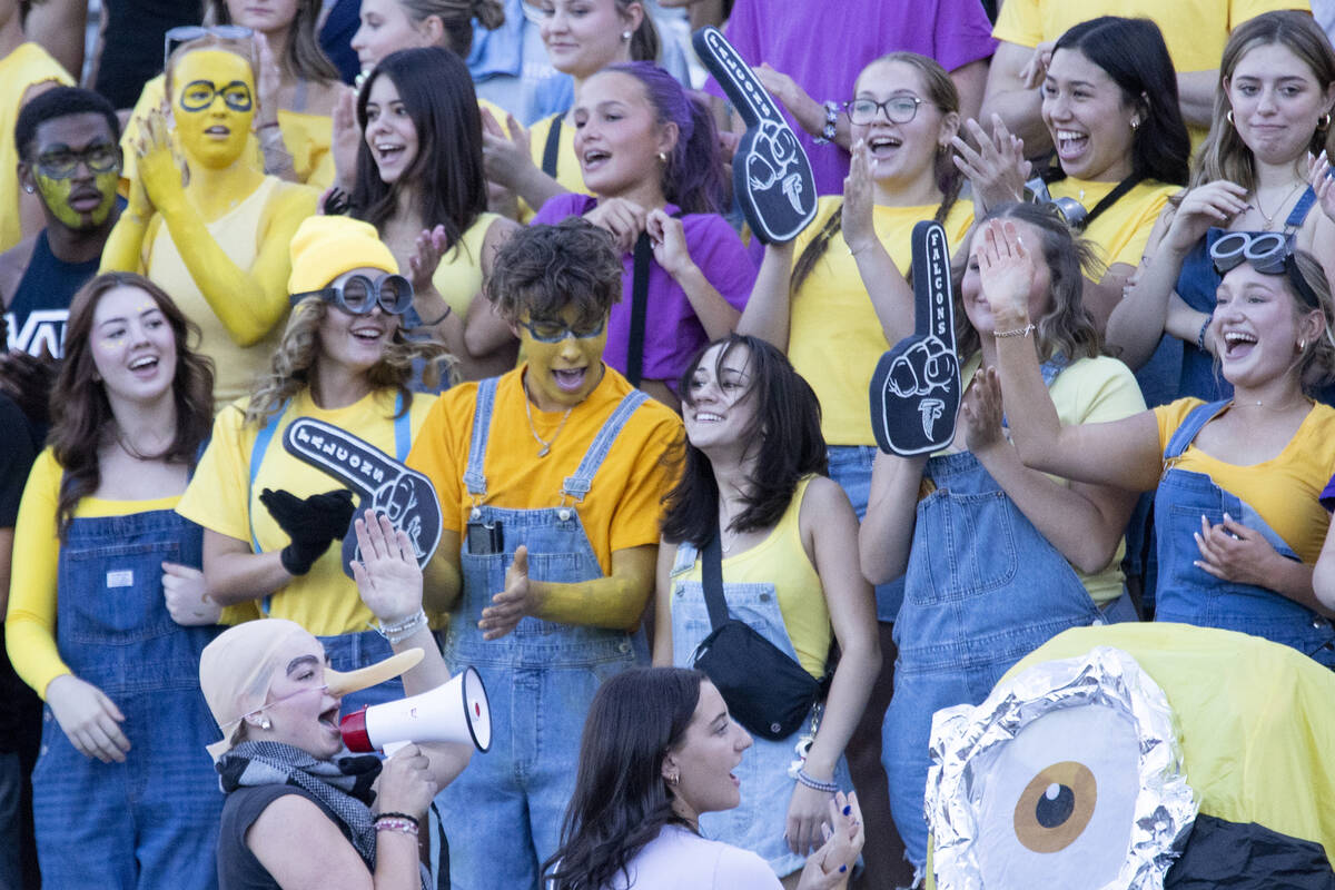 The Foothill student section cheers while dressed as minions during the high school football ga ...