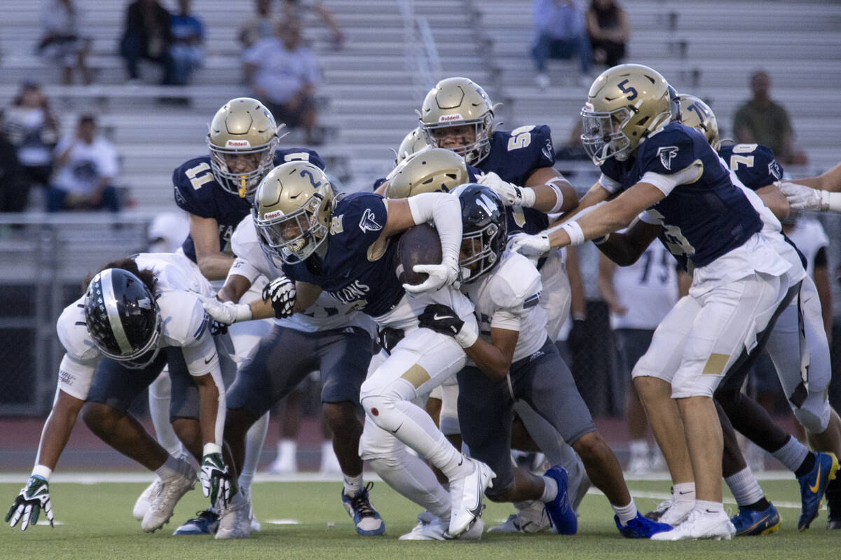 Foothill senior Avant Gates Jr. (2) drags Desert Pines defensive players, making a first down d ...