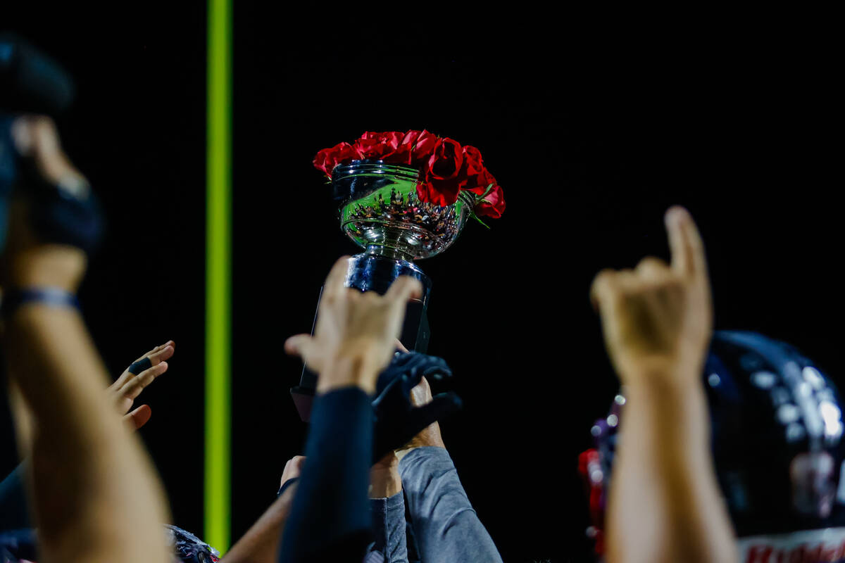 Coronado lifts trophy after defeating Liberty after a football game between Liberty and Coronad ...