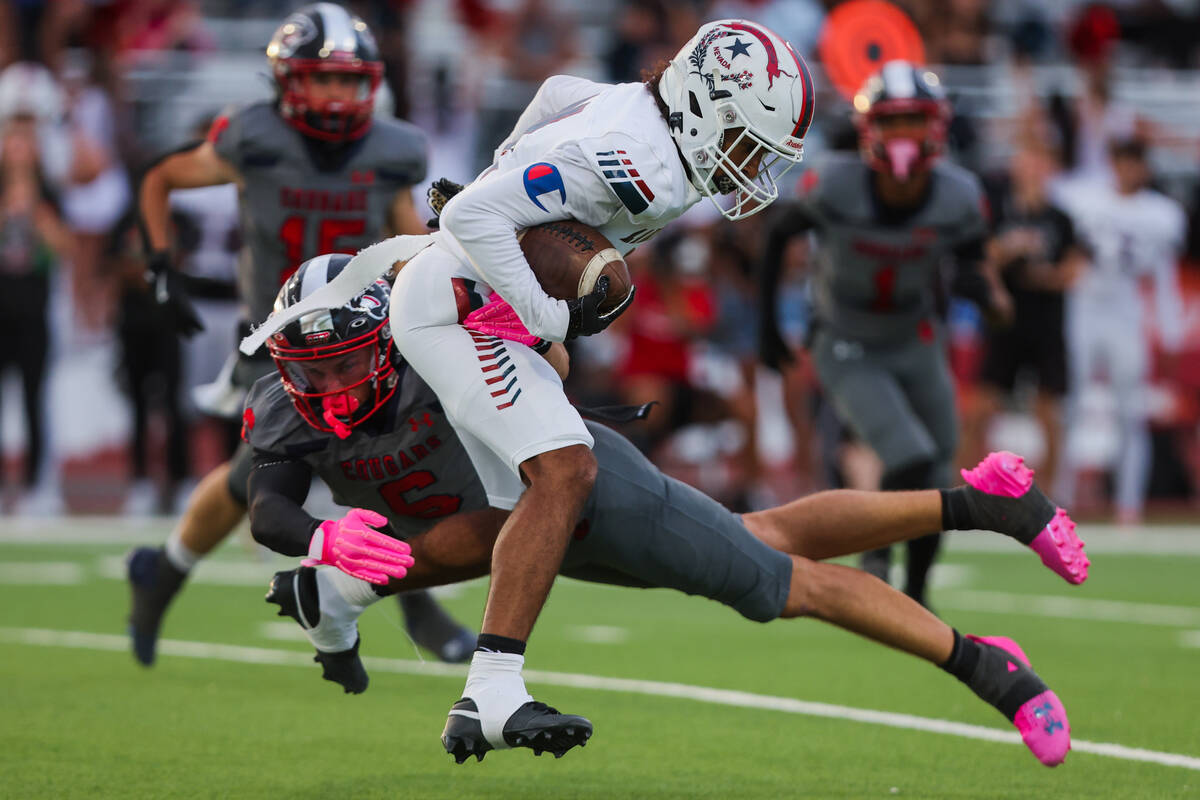 Coronado’s JJ Buchanan (6) grabs Liberty wide receiver Giovanni Criss (4) during a footb ...