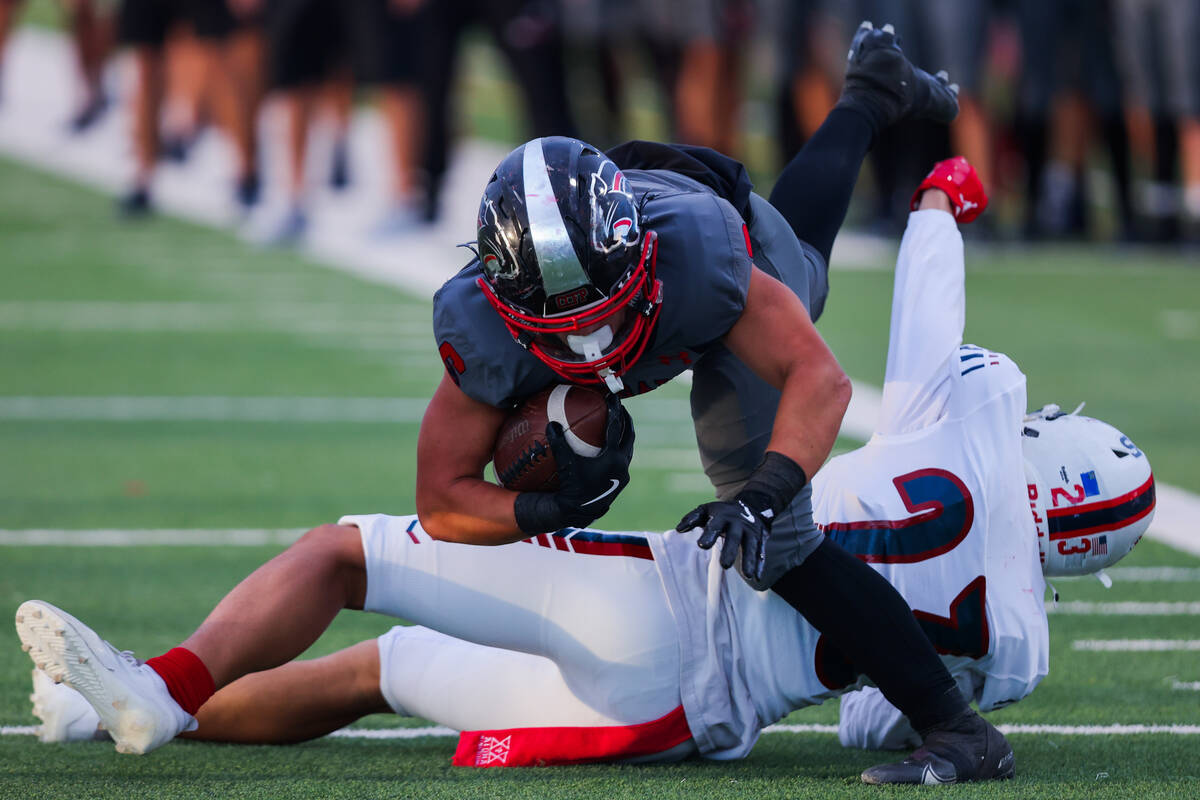 Coronado’s JJ Buchanan (6) dives over Liberty defensive back Marley Ganiron (27) to near ...