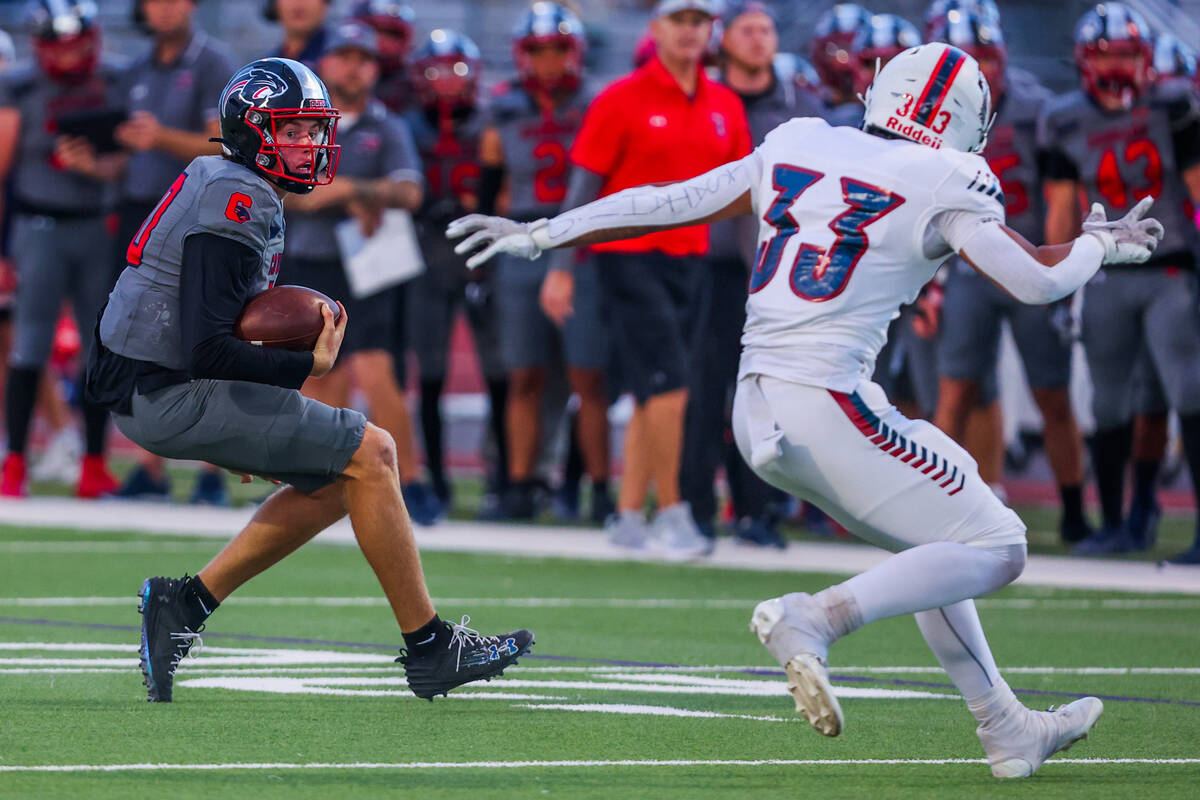 Coronado quarterback Aiden Krause (10) scrambles as Liberty linebacker Jaydrien Klein-Baker tri ...