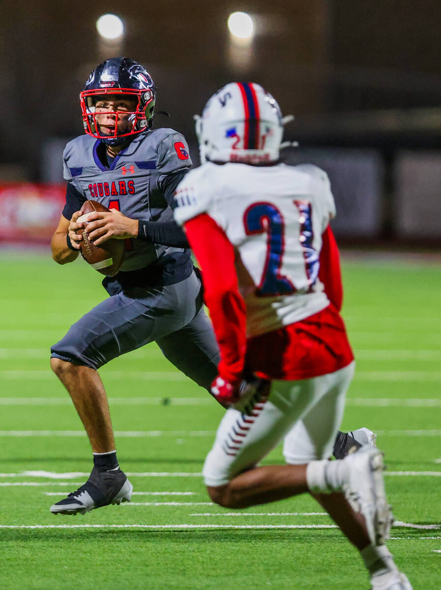 Coronado quarterback Jackson Humphries (4) scrambles as he finds a teammate to pass the ball to ...