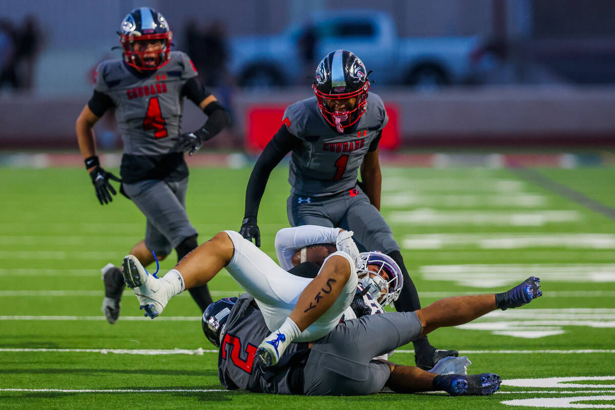 Liberty running back Ezra Sanelivi (1) is brought down by Coronado defensive back Isaiah Colber ...