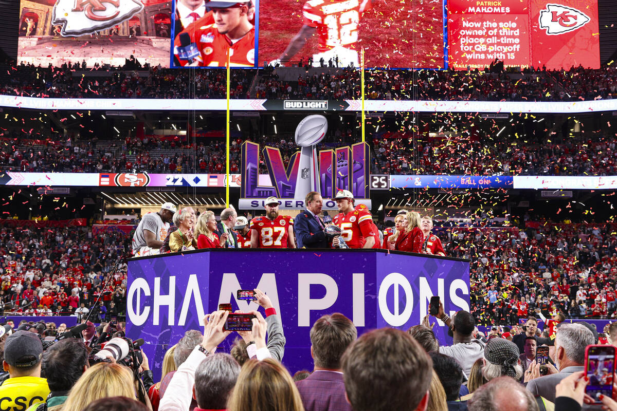 Kansas City Chiefs quarterback Patrick Mahomes (15) holds the Vince Lombardi Trophy after winni ...