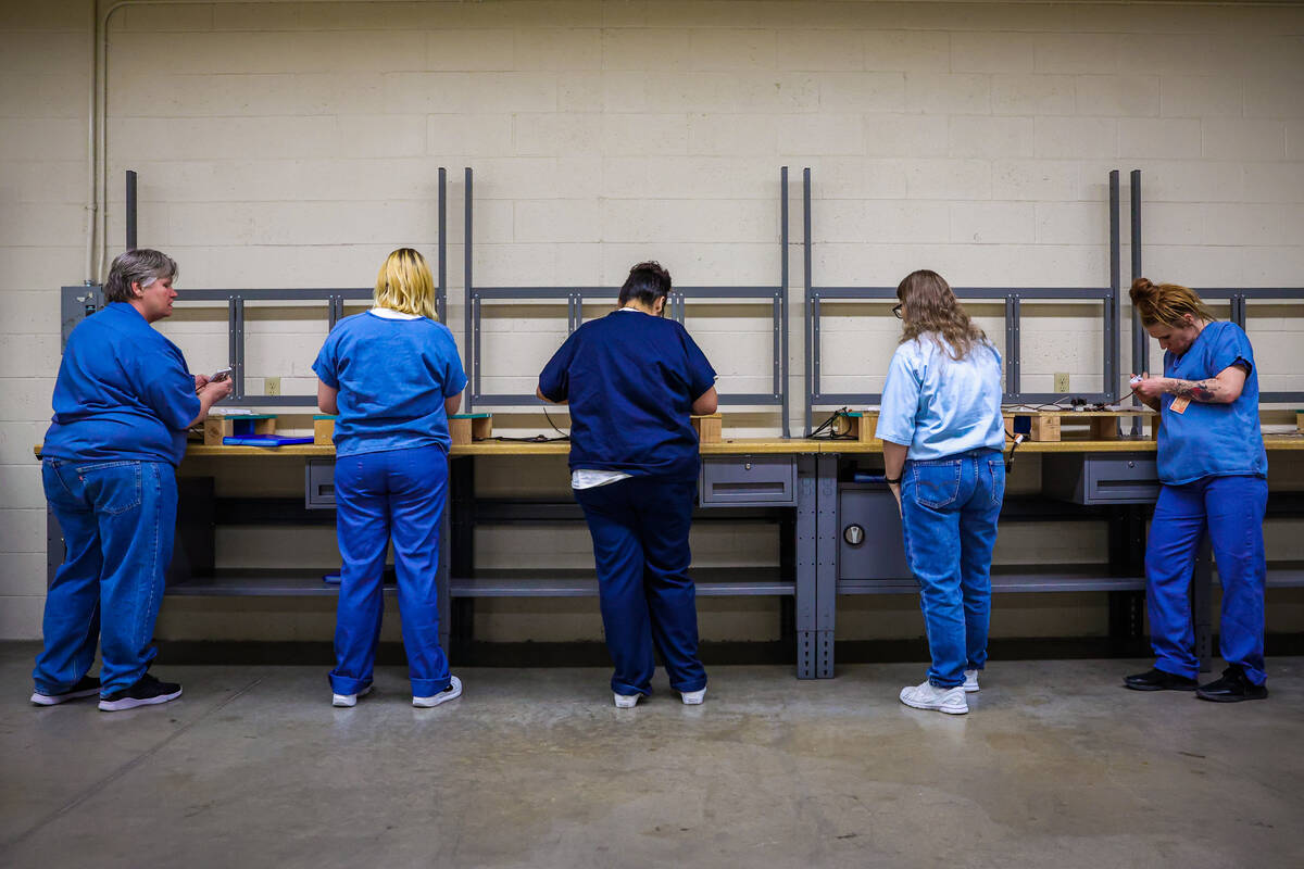 Students work on properly wiring digital thermostats during a HVAC class for inmates at Florenc ...