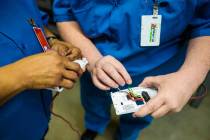 Students work on properly wiring digital thermostats during a HVAC class for inmates at Florenc ...