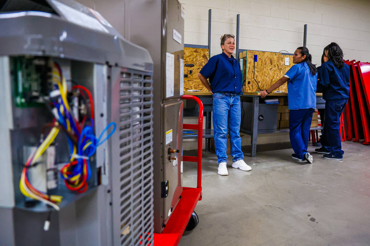 Students stand at their individual stations during a HVAC class for inmates at Florence McClure ...