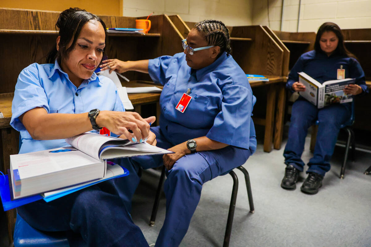 Crystal Sashinger flips through a textbook during a HVAC class for inmates at Florence McClure ...