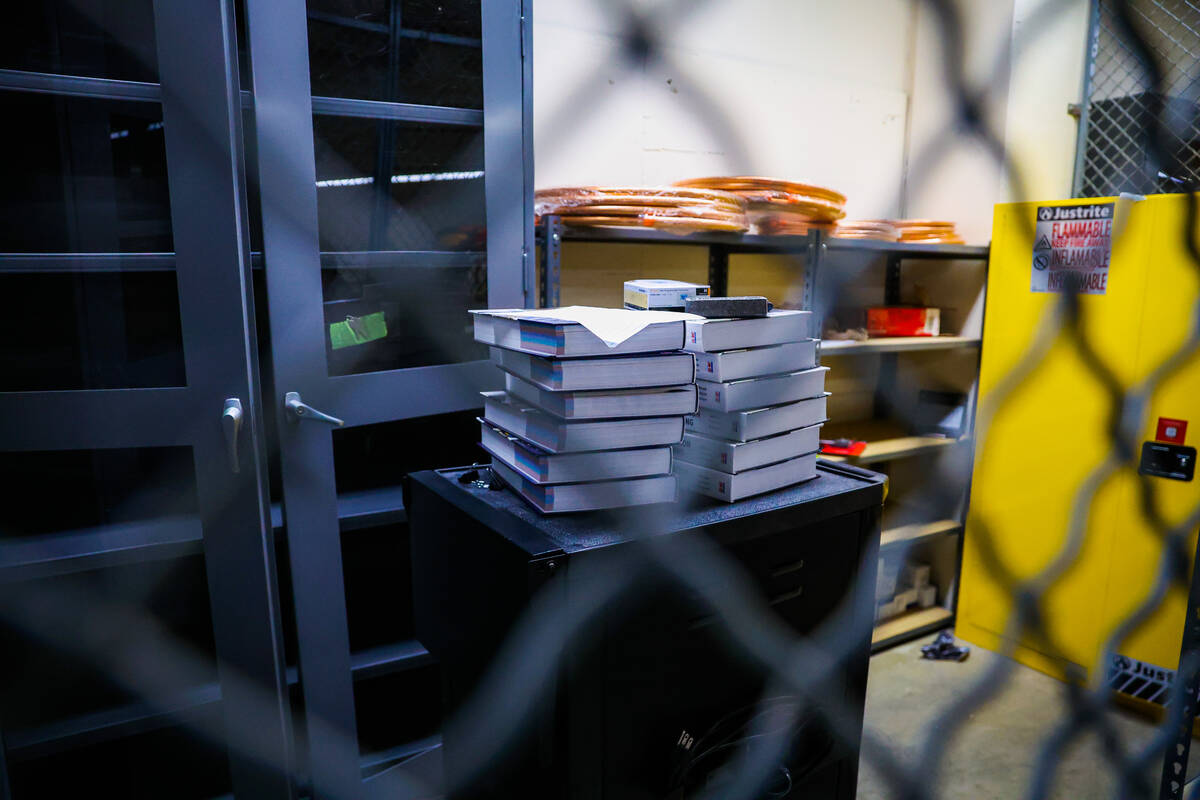 Hardcover textbooks are kept in a locked area before a HVAC class for inmates at Florence McClu ...