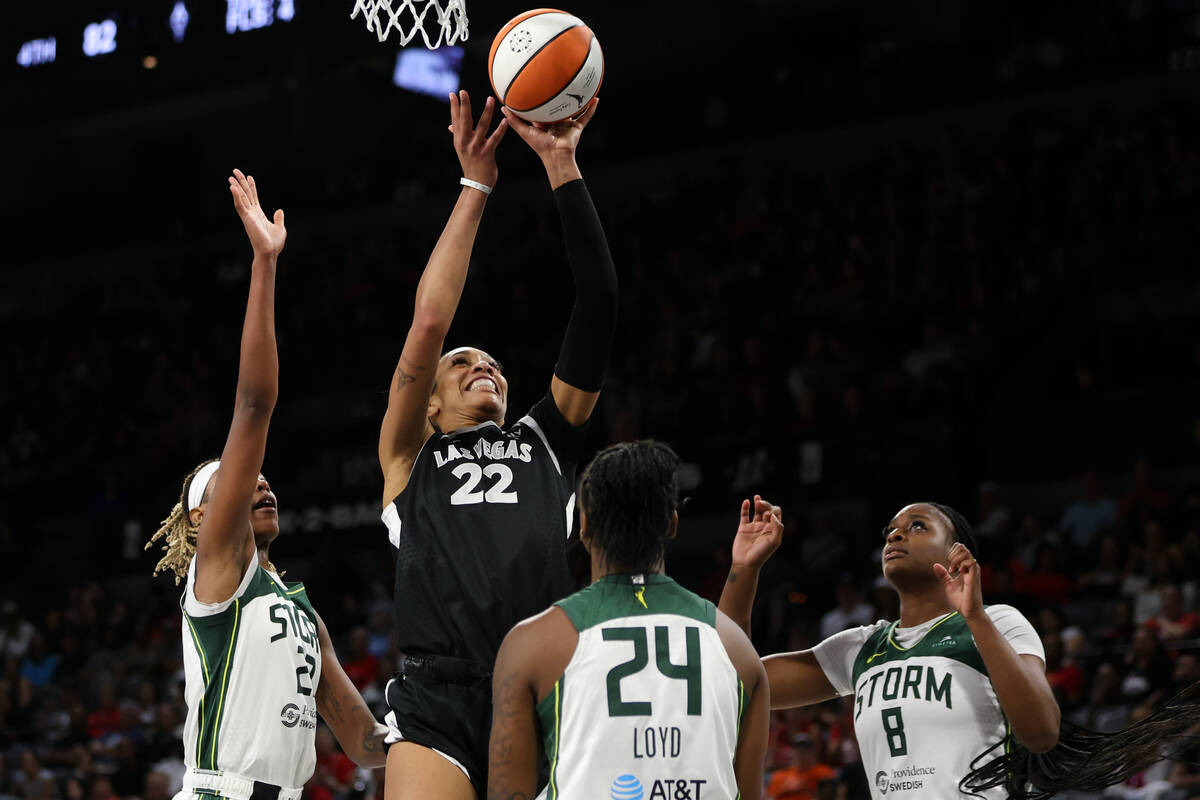 Las Vegas Aces center A'ja Wilson (22) shoots against Seattle Storm guard Jordan Horston, left, ...